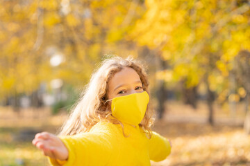 Poster - Happy child wearing protective mask in autumn park