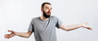 © Daria Lukoiko - Portrait of a cheerful young man smiling while looking at the camera, throwing up his hands to the sides from ignorance on a white background with a place for advertising mockup