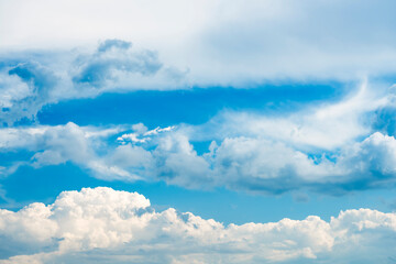Wall Mural - Stunning view of a blue sky with some fluffy clouds. Aerial shoot, natural background with copy space.