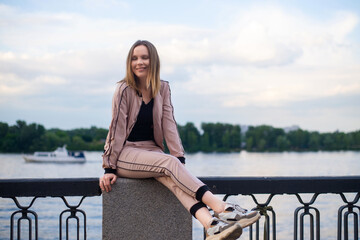 happy woman 40 years old on the embankment of the river