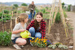 © JackF - Mother and daughter watering plants at garden
