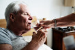 © Rawpixel.com - Caucasian senior man drinking water in his bed