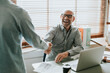 © Rawpixel.com - Businessman in an office shaking hands