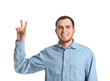 © Pixel-Shot - Handsome man showing victory gesture on white background