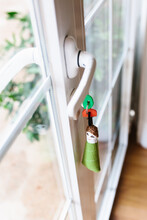 Soft Fabric Key Chain With Keys Sticking Out From Keyhole Of Terrace Door