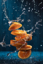 Splash Of Sliced Orange With Water Drops