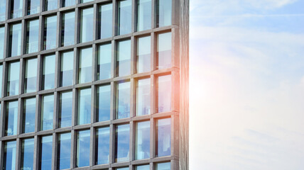 Abstract image of looking up at modern glass and concrete building. Architectural exterior detail of office building. Industrial art and detail. Sunrise.