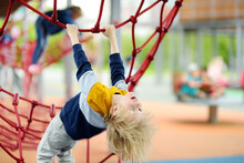 Perky Preschooler Boy Having Fun On Outdoor Playground. Spring/summer/autumn Active Sport Leisure For Kids. Outdoor Activities For Children.