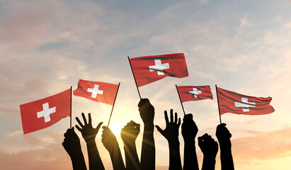 Sticker - Silhouette of arms raised waving a Switzerland flag with pride. 3D Rendering