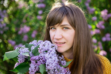 beautiful young mother with long dark hair walks in the park. Fresh summer air. Family summer walks