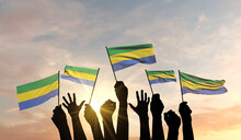 Silhouette Of Arms Raised Waving A Gabon Flag With Pride. 3D Rendering