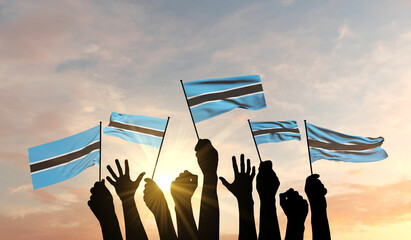 Sticker - Silhouette of arms raised waving a Botswana flag with pride. 3D Rendering