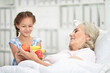 © aletia2011 - Granddaughter visiting  grandmother  in hospital