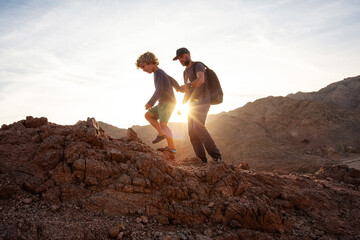 Wall Mural - Dad with son in the mountains in the desert