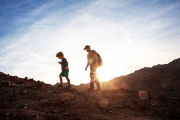 Wall Mural - Dad with son in the mountains in the desert