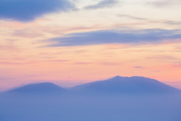 Wall Mural - Winter arctic landscape. View of the snow-capped mountains at sunset. Cold winter weather. Frosty fog over the tundra. Picturesque arctic nature. Mount Dionysius, Chukotka, Siberia, Far North Russia.