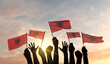 Silhouette of arms raised waving a Albania flag with pride. 3D Rendering