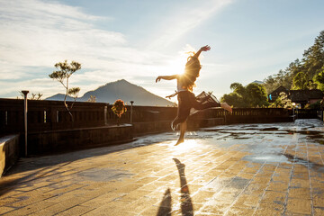 Sticker - Woman doing yoga at dawn near a volcano on the island of Bali