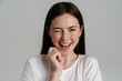 © Drobot Dean - Young brunette woman winking and laughing at camera
