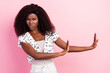 Photo of disgusted unhappy afro american young woman hold hands rejection bad mood isolated on pink color background