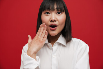 Wall Mural - Young asian woman wearing shirt expressing surprise at camera