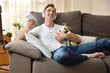 © Davizro Photography - Happy man on sofa listening music with dog