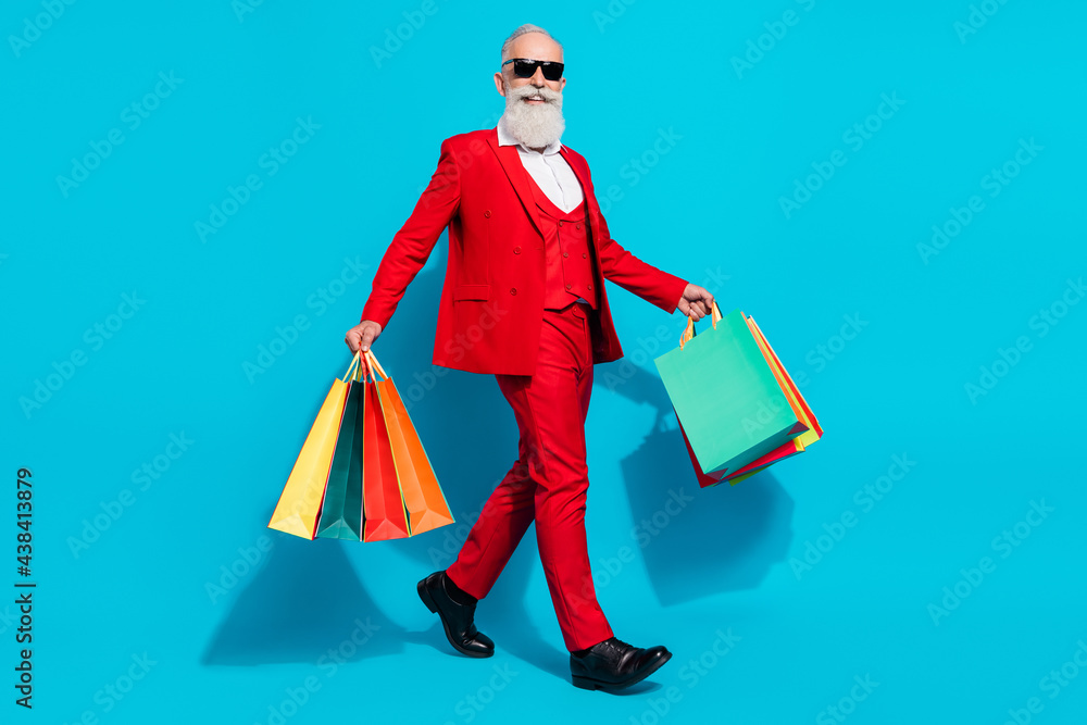 Full length body size photo aged man keeping packages walking forward isolated vivid blue color background - obrazy, fototapety, plakaty 