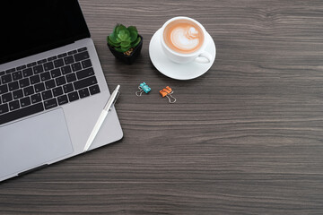 Wall Mural - Work form home, Mockup home office table desk with laptop computer and pen, green plant and coffee cup, top view with copy space