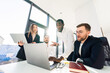 © Andrii  - Employees of financial corporation watch the growth of their company's shares on a laptop