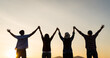 © Siam - Group of happy friends are having fun with raised arms together in front of mountain and enjoy sunrise sunset showing unity and teamwork. Friendship happiness leisure partnership team concept.