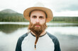 © ADDICTIVE STOCK - Man with braided beard near lake