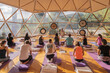 © ADDICTIVE STOCK - People doing yoga on yoga mats in domed hall