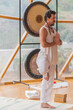 © ADDICTIVE STOCK - Calm man folding arms and raising leg in vrikshasana pose in yoga class
