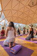 © ADDICTIVE STOCK - People doing yoga on yoga mats in domed hall