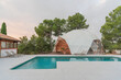 © ADDICTIVE STOCK - Domed yoga room by pool with crystal water