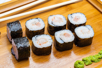 Philadelphia roll sushi with salmon, shrimps, avocado, cream cheese. Sushi menu. Japanese food..Sushi roll isolated on white close up