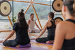 © ADDICTIVE STOCK - People doing yoga on yoga mats in domed hall