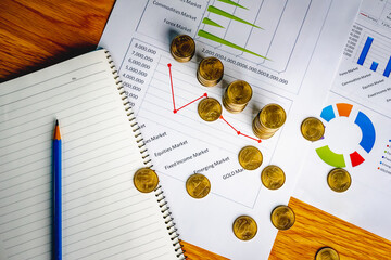 Saving money as a concept. Vintage retro stack of gold coins on the wooden background to represent It's time to do investing for retirement planning.