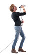 © sharplaninac - Side view of emotional passionate rock music singer screaming loud on microphone. Full body length isolated on white background.