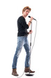 © sharplaninac - Profile view of cool handsome rock music singer posing with microphone on stand. Full body length isolated on white background.