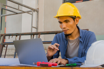 Worker employee working by computer technology on site construction