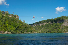 Cable Car Of Funicular Railway With Tourists Running Over The Niagara River At Whirlpool, View From The Bottom Of The Gorge. Sunny Summer Day.