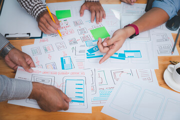 UX or UI designers designing on their smartphone application layout prototype project.