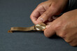 Hands of a man winding an old gold watch