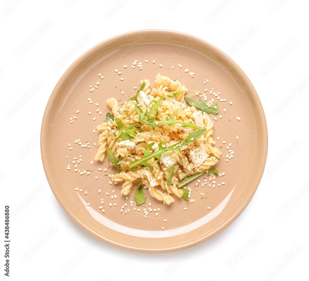 Plate with tasty pasta and arugula on white background