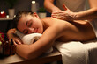 © H_Ko - Young woman relaxing during back massage at spa