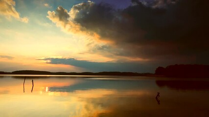 Wall Mural - Beautiful evening sky reflected in waters of lake. Spectacular landscape.