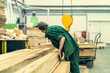 © DedMityay - Unrecognizable worker in timber workshop at woodworking plant.