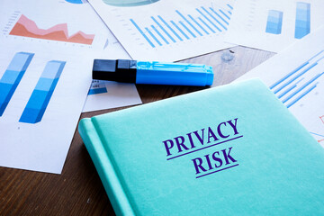 Financial concept about PRIVACY RISK with sign on the book cover.