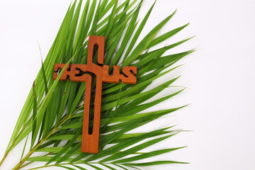 Wall Mural - Cross and palm on white background with copyspace. Palm Sunday concept